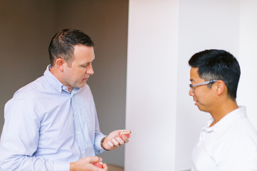 Dr. Bates talking to patient about grinding teeth and Invisalign