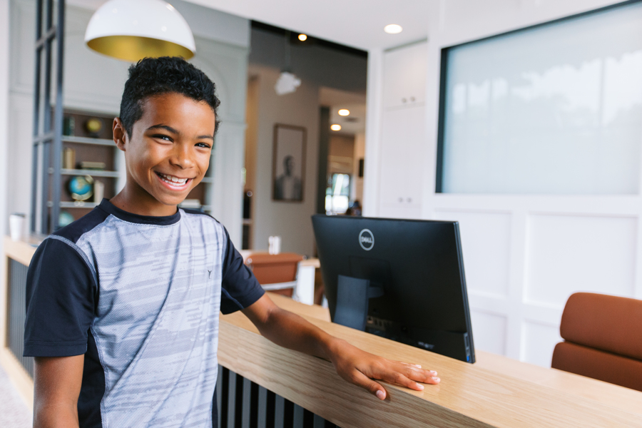 young kid at checking into orthodontist office