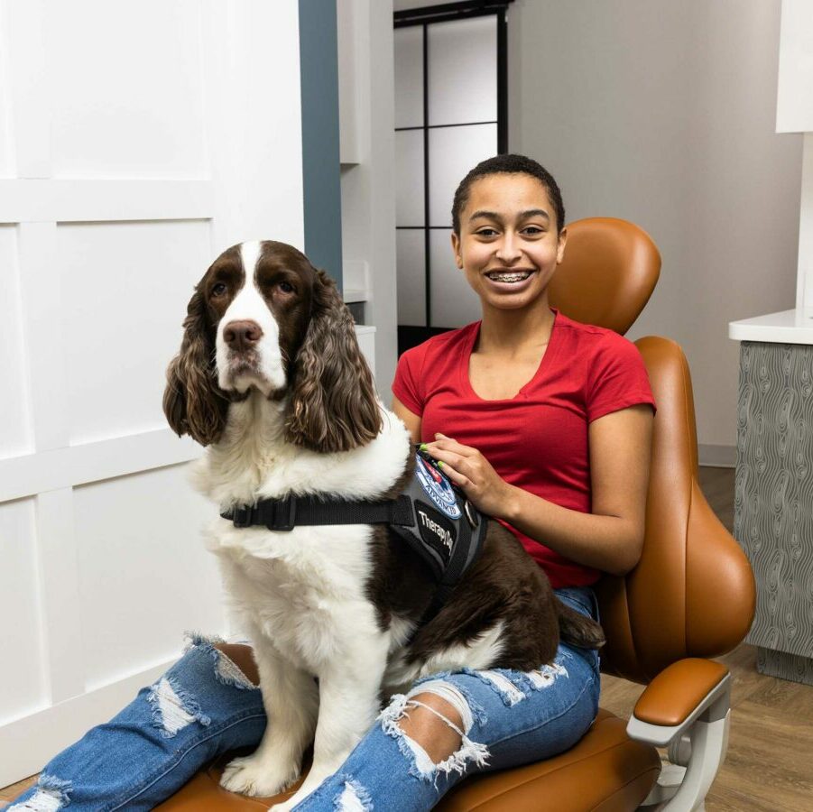 Therapy Dog with Patient Bates Orthodontics Staff with Patients