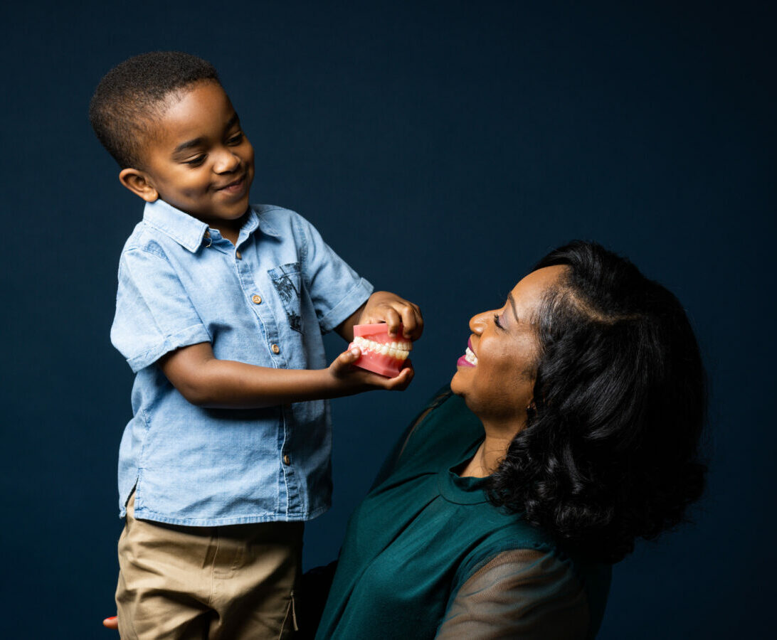 Little kid showing his mom retainers