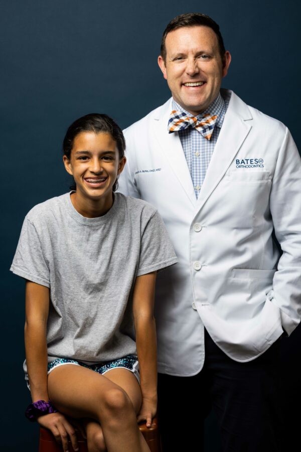 Dr. Bates smiles with a teen patient